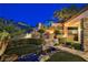 Beautifully landscaped backyard with a stream, patio area, and built-in grill, perfect for outdoor entertaining at 40 Stonemark Dr, Henderson, NV 89052