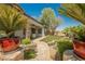 Beautiful backyard with stone path leading to patio, pond and lush landscaping at 40 Stonemark Dr, Henderson, NV 89052