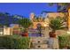 Outdoor patio with built-in BBQ, seating, and beautiful desert landscaping, perfect for entertaining at 40 Stonemark Dr, Henderson, NV 89052