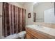 Bathroom with a patterned shower curtain and tile countertop at 40 Stonemark Dr, Henderson, NV 89052