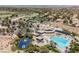 Expansive aerial view showcasing the clubhouse, pool, tennis courts, and neighborhood at 40 Stonemark Dr, Henderson, NV 89052