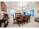 Elegant dining room with classic decor, featuring a chandelier, large windows, and ample seating at 40 Stonemark Dr, Henderson, NV 89052