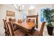 Elegant dining room featuring wainscoting, chandelier lighting, and a large wooden table with seating for eight at 40 Stonemark Dr, Henderson, NV 89052