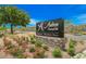 An Anthem Country Club sign is surrounded by beautiful landscaping with red flowers and green foliage at 40 Stonemark Dr, Henderson, NV 89052