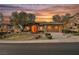 Beautiful single-story home with desert landscaping, a stone facade, and three-car garage at 40 Stonemark Dr, Henderson, NV 89052