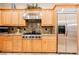 Close up shot of kitchen with stainless appliances, custom cabinets, and stone countertops at 40 Stonemark Dr, Henderson, NV 89052