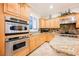 Kitchen featuring stainless steel double ovens and stone countertops with seating at 40 Stonemark Dr, Henderson, NV 89052