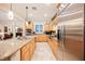 Galley-style kitchen with stainless steel appliances, granite counters, and custom wooden cabinets at 40 Stonemark Dr, Henderson, NV 89052