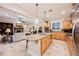 Open concept kitchen with granite island and stainless appliances with an open view to the living area at 40 Stonemark Dr, Henderson, NV 89052