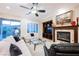 Comfortable living room featuring a fireplace and backyard views at 40 Stonemark Dr, Henderson, NV 89052