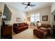 Living room with a ceiling fan, plantation shutters, and comfortable seating at 40 Stonemark Dr, Henderson, NV 89052