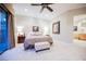 Spacious main bedroom with a plush carpet, tray ceiling, and access to a private outdoor space at 40 Stonemark Dr, Henderson, NV 89052