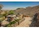 Outdoor kitchen area with grill, fire pit, desert landscaping, and hilltop view at 40 Stonemark Dr, Henderson, NV 89052