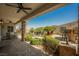Inviting outdoor patio featuring stone pillars, ceiling fans, and dining seating at 40 Stonemark Dr, Henderson, NV 89052