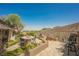 Outdoor patio with seating, lush landscaping, and built-in BBQ at 40 Stonemark Dr, Henderson, NV 89052