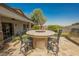 Outdoor patio featuring elegant chairs, built-in grill, and a relaxing atmosphere at 40 Stonemark Dr, Henderson, NV 89052