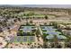 Aerial view of multiple well-maintained tennis courts surrounded by desert landscaping and greenery at 40 Stonemark Dr, Henderson, NV 89052
