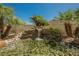 Close-up of a serene stone waterfall and pond with lush landscaping at 40 Stonemark Dr, Henderson, NV 89052