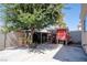 Cozy backyard features a spacious concrete patio area, a built-in chicken coop, and mature trees, perfect for outdoor relaxation at 4945 Volcanic Rock Ln, Las Vegas, NV 89122