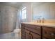 Bathroom with a marble-tiled shower, modern fixtures, vanity with drawers and solid surface countertop at 4945 Volcanic Rock Ln, Las Vegas, NV 89122