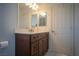 Bathroom featuring a double vanity with drawers and doors, solid surface countertop, and mirror at 4945 Volcanic Rock Ln, Las Vegas, NV 89122