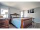 Comfortable bedroom featuring a wooden bed frame, stylish bedding, and a wall-mounted television at 4945 Volcanic Rock Ln, Las Vegas, NV 89122