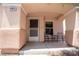 Close up on a covered porch with space for a table and chairs by the front door at 4945 Volcanic Rock Ln, Las Vegas, NV 89122