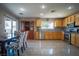 Modern kitchen and dining area with stainless steel appliances and sleek, gray accented chairs at 4945 Volcanic Rock Ln, Las Vegas, NV 89122