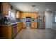 Bright kitchen with stainless steel appliances and breakfast bar open to another room at 4945 Volcanic Rock Ln, Las Vegas, NV 89122