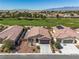 Expansive aerial view of a residential area with lush green golf course and mountain views at 5341 E La Campana Dr, Pahrump, NV 89061
