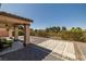 The covered patio offers outdoor relaxation, with stunning desert landscaping and view fencing at 5341 E La Campana Dr, Pahrump, NV 89061