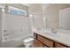 Bright bathroom features a white tile shower, a single sink vanity, and ample natural light at 5341 E La Campana Dr, Pahrump, NV 89061