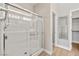 This updated bathroom features glass shower with a showerhead, walk-in closet, and wood look flooring at 5341 E La Campana Dr, Pahrump, NV 89061
