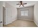 Clean bedroom with wood-look flooring, neutral paint, and a window with plantation shutters at 5341 E La Campana Dr, Pahrump, NV 89061