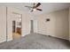 Bedroom with neutral colors and carpet flooring, ceiling fan, access to bathroom and large closet at 5341 E La Campana Dr, Pahrump, NV 89061
