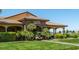 Inviting clubhouse with stone accents and a pro shop, surrounded by manicured lawns and lush landscaping at 5341 E La Campana Dr, Pahrump, NV 89061