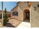 Inviting front entrance featuring an arched entryway, decorative door, and well-maintained landscaping at 5341 E La Campana Dr, Pahrump, NV 89061