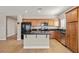 An open kitchen with an island, wooden cabinets, and stainless steel appliances at 5341 E La Campana Dr, Pahrump, NV 89061