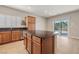 Bright kitchen features wood cabinets, stainless steel appliances, granite countertops and center island at 5341 E La Campana Dr, Pahrump, NV 89061