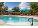 Inviting pool area with lounge chairs and umbrellas, providing a perfect spot for relaxation and recreation at 5341 E La Campana Dr, Pahrump, NV 89061