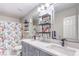 Bathroom featuring double sink vanity with modern fixtures and a shower-tub combination with patterned curtain at 5453 Palisades Quad Ave, Las Vegas, NV 89122