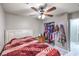Bedroom boasts ceiling fan, closet, and comfortable bed, blending functionality with simple design elements at 5453 Palisades Quad Ave, Las Vegas, NV 89122