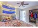 Cozy bedroom featuring flag tapestry, a comfortable bed adorned with plush toys and an organized closet space at 5453 Palisades Quad Ave, Las Vegas, NV 89122