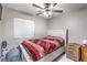 Bedroom with neutral walls, ceiling fan, and comfortable bed complemented by a U-Haul box and additional storage at 5453 Palisades Quad Ave, Las Vegas, NV 89122