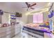 Bedroom features a dresser with mirror and a bed dressed with colorful textiles under soft string lights at 5453 Palisades Quad Ave, Las Vegas, NV 89122
