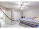 Bedroom featuring tiled floors, ceiling fan, and a closet with sliding doors, offering a simple and functional space at 5453 Palisades Quad Ave, Las Vegas, NV 89122