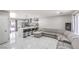 Modern open-concept living area featuring a bar, sofa, and easy access to the kitchen at 5453 Palisades Quad Ave, Las Vegas, NV 89122