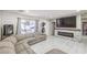Open-concept living room featuring a cozy sectional couch, fireplace, and large TV at 5453 Palisades Quad Ave, Las Vegas, NV 89122