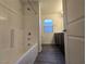 Bathroom with combined bathtub and shower, vanity, and window at 5817 Bonita Rose St, Las Vegas, NV 89113
