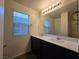 Bathroom with a large mirror, double vanity, and bright lighting at 5817 Bonita Rose St, Las Vegas, NV 89113